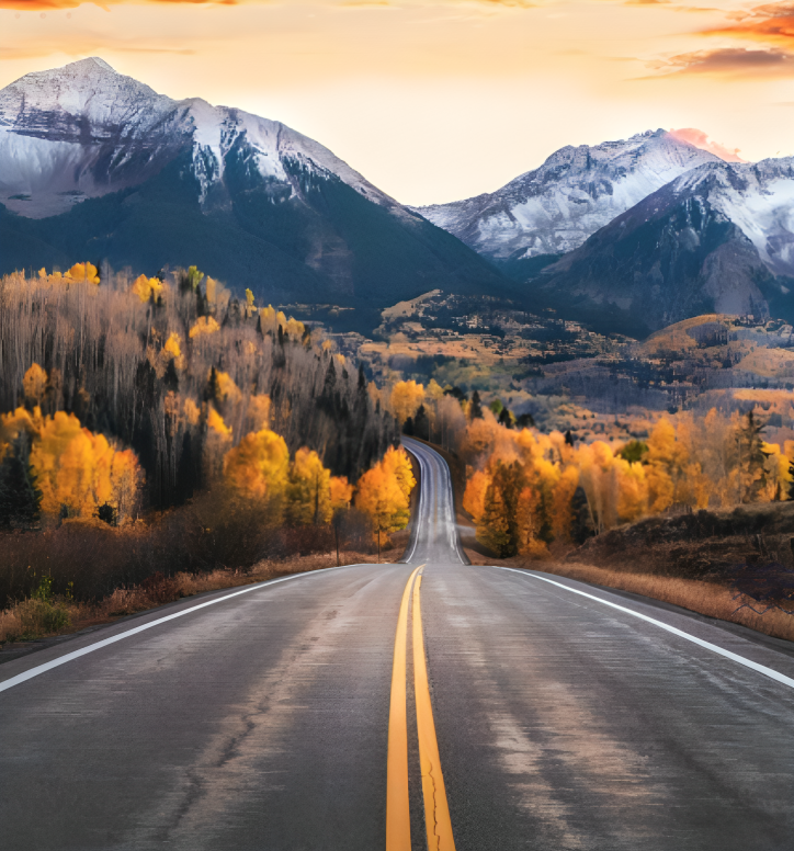 A road with two lanes and mountains in the background.